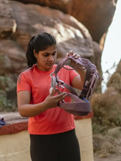 An instructor holds up a harness to explain its features. Our workshops cover all the details of your gear so you feel comfortable and knowledgeable.