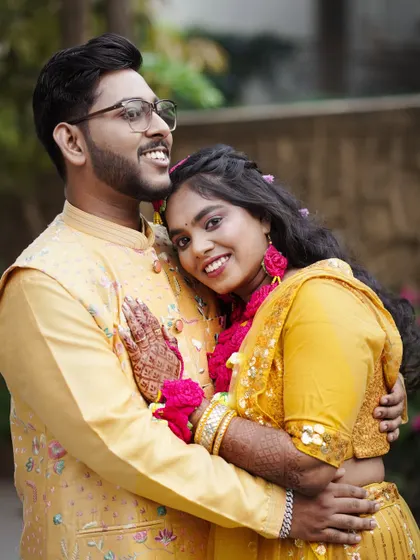 A warm and affectionate portrait of a couple embracing during their Haldi ceremony.