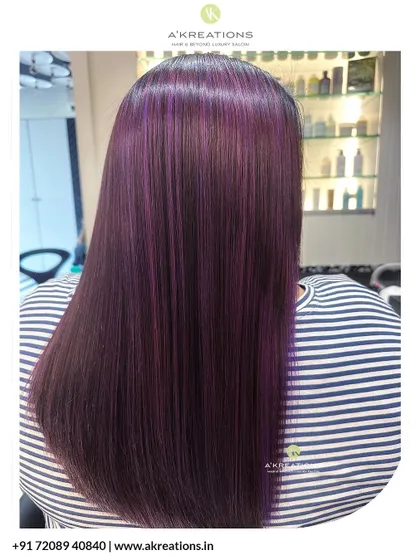 Serving shades of royalty with this vibrant violet hair color. The sleek, straight styling makes the color pop even more.