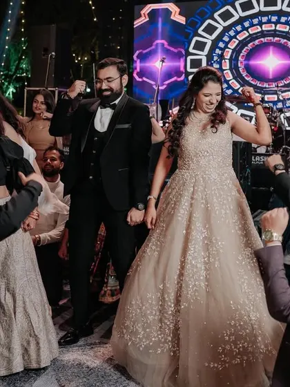 A wide shot of the couple and their friends enjoying the music and dancing the night away.