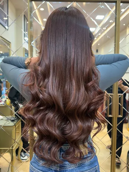 The back view of this glossy Mocha Mousse color. The hair looks incredibly healthy and full of volume.