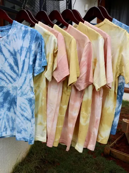 A full rack of our naturally dyed tees, ready to find new homes. Each one is a testament to the beauty of handmade and sustainable fashion.