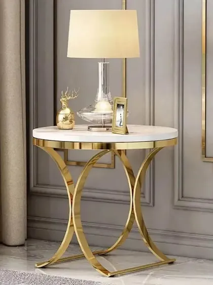 A classic and elegant stainless steel side table with a gold electroplating finish and a white marble top, perfect for placing next to a sofa or bed.