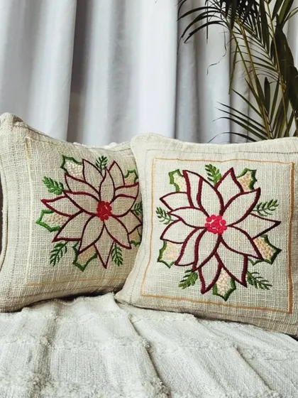 A festive floral embroidered cushion cover, perfect for special occasions or adding a touch of celebration to your everyday decor.
