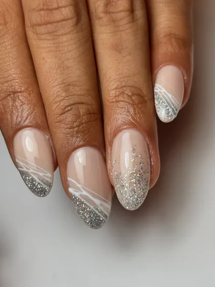 The full set of the silver glitter and spider gel nails. The abstract white lines add a cool, graphic element to the sparkly base.
