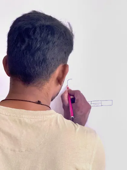 A close-up of the initial design sketch being drawn directly onto the wall. This is where the vision starts to take physical form.