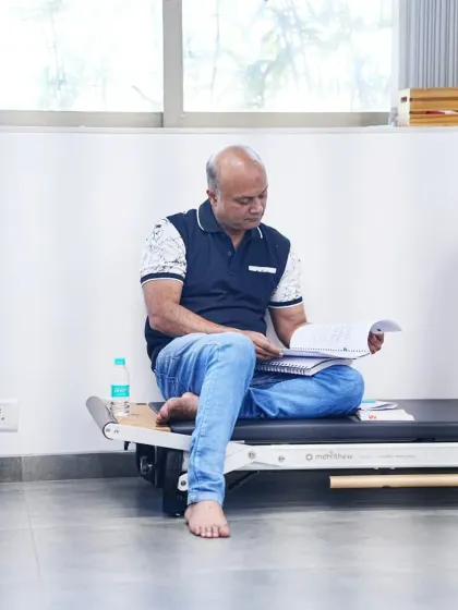 The curriculum is comprehensive. A student reviews the detailed course material covering everything from electrophysiological basics to client consultation protocols.