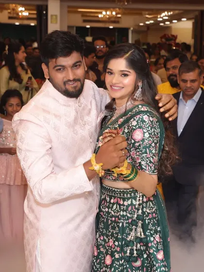 A moment of celebration during their engagement. Her natural, glowing makeup stays perfect even during the most energetic moments.