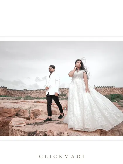 A full-length shot of the couple at the Gandikota fort, with the wind catching the bride's dress, creating a dynamic and beautiful pre-wedding portrait.