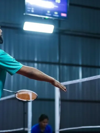 A player serves during a match at our GOAT Vision launch. The clear court lines, good lighting, and quality nets all contribute to a seamless playing experience.