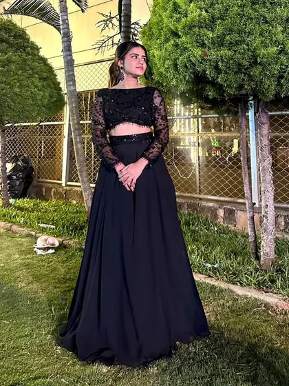 The full view of the elegant black lehenga, perfect for an evening event.