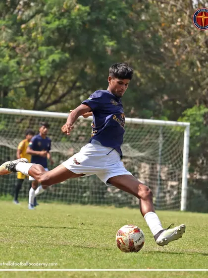 A player striking the ball with perfect technique in an A Division match. My goal is to develop technically sound players who can compete at the highest levels.