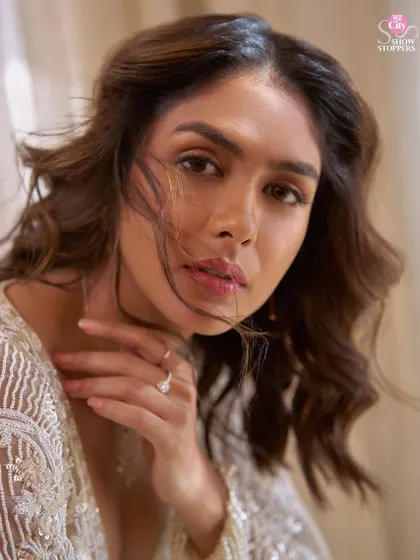 A close-up from the Mrunal Thakur shoot. The soft lighting and windswept hair complement the delicate embroidery of the jacket, showcasing a moment of quiet beauty.