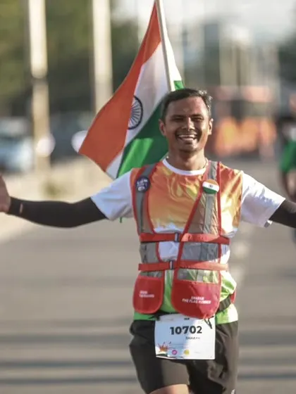 The spirit of patriotism and fitness combined. A runner joyfully carries the Indian flag during our Independence Day Freedom Run.