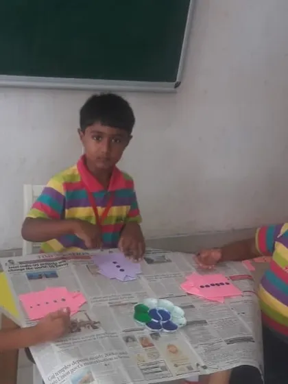 Students are focused on their Father's Day craft, a hands-on activity that is both fun and meaningful.
