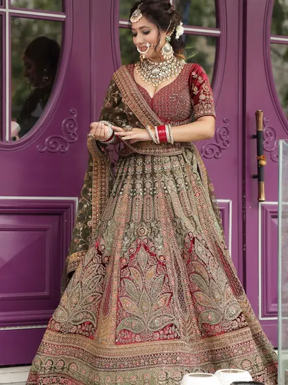 A stunning multi-tonal embroidered lehenga in shades of green and maroon, a heavy and regal option for a bride.