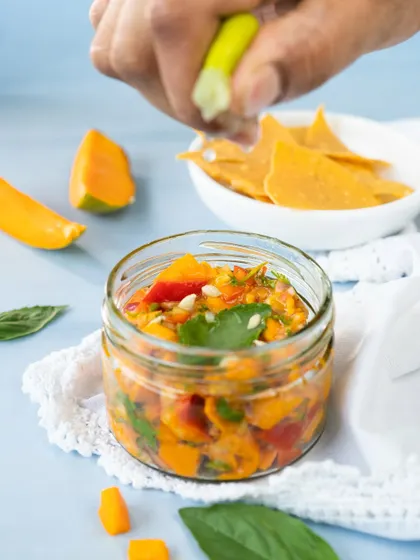 A squeeze of fresh lime is the finishing touch on our seasonal Mango Salsa. It's sweet, tangy, and the perfect companion for nacho chips on a sunny day.