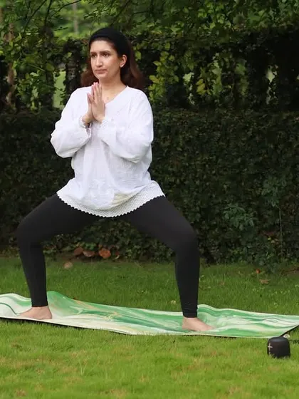 Demonstrating Utkata Konasana, or Goddess Pose, during an outdoor class. This pose is fantastic for building strength in the legs and opening the hips.