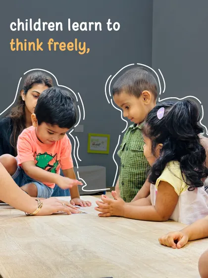 Children learn to think freely and collaborate with their peers. This image shows a group of kids working together on a table-top activity, developing social skills and learning from one another.