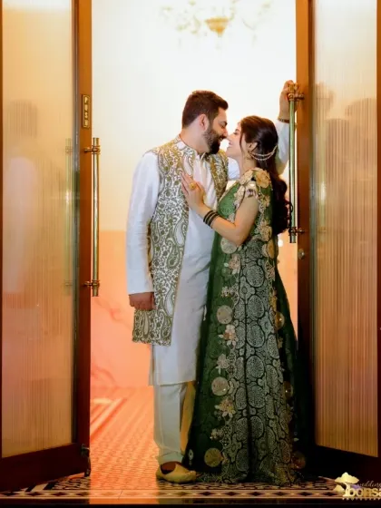 An intimate portrait of the couple in a doorway, sharing a quiet moment amidst the celebration.