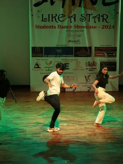 Our dancers executing a powerful, synchronized kick during their performance. We teach technique and precision to make every move impactful.