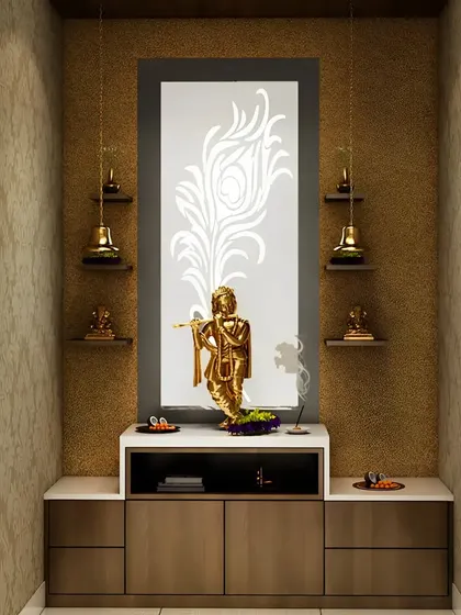 A beautiful pooja space with a backlit panel featuring a peacock feather design. The setup includes a golden Krishna idol and small shelves for brass lamps.