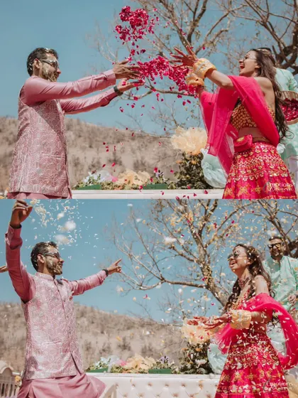 A dynamic shot of the couple playfully throwing flower petals at each other during their Haldi, full of movement and laughter.