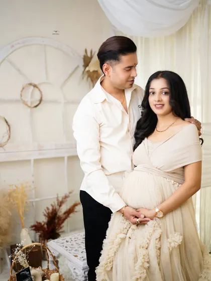A classic and beautiful portrait of the expecting couple. Their happy smiles and the warm, neutral tones of the boho set create a timeless and heartwarming image.