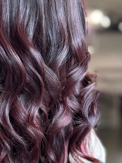 A close-up on the dreamy burgundy waves, capturing the glossy finish and rich color.