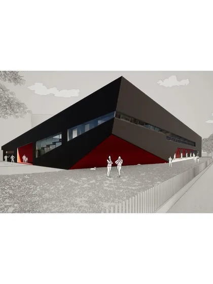 The building presents a linear, monolithic form to the adjoining arterial road, asserting its public presence.