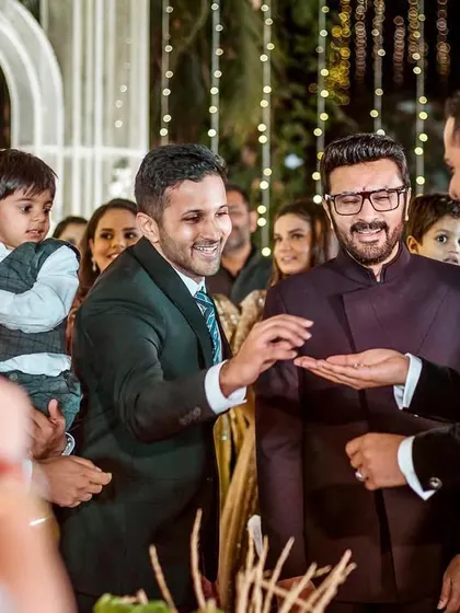 The ring is found. The groom's brothers and friends share a laugh as the ring is finally presented for the ceremony.
