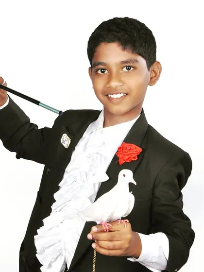A classic magician's portrait with a dove and wand. Learning to handle live animals was an important step in my development as a performer.