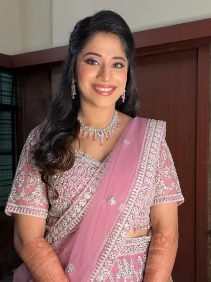 Another angle of Harshitha's reception glam. The soft half-up hairstyle and diamond jewelry complete this elegant and modern bridal look.