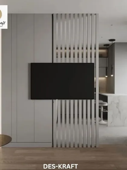 A unique slatted room divider with an integrated TV mount separates the living area from the kitchen while maintaining a sense of openness.