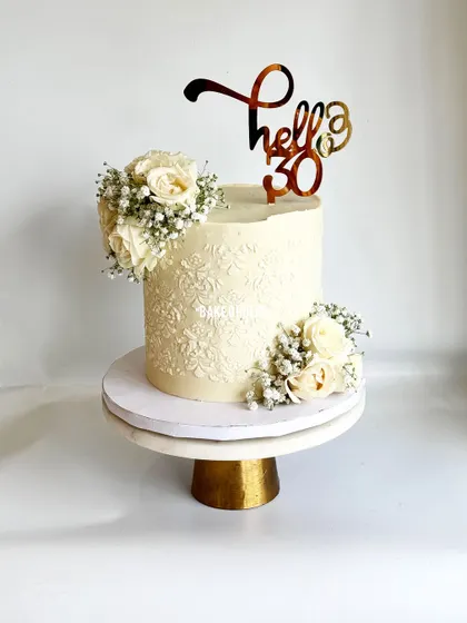 Classic white can never go wrong. This 2.5kg Chocolate truffle cake for a 30th birthday has a beautiful stencil pattern and is decorated with fresh white roses and baby's breath.