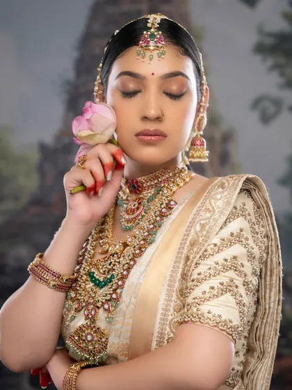 A moment of quiet elegance. This close-up shows the flawless eye makeup and the intricate details of the temple jewelry.