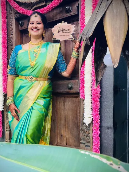 The bride's joyful smile says it all. This photo captures the happiness of the moment, with her makeup and styling looking perfect against the traditional decor.