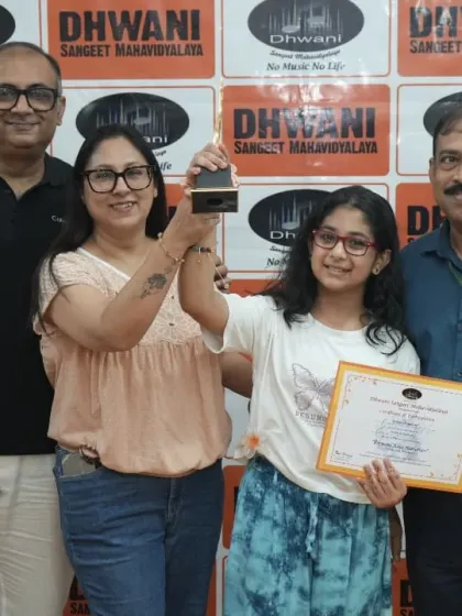 A student with her family, celebrating her musical award.