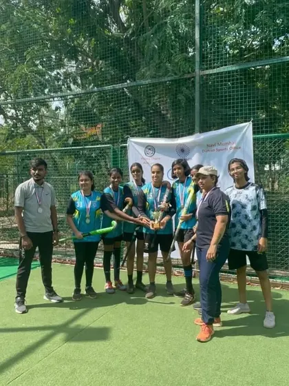 Our girls' team receives their trophy from the coaches. We believe in celebrating every achievement, big or small, to build confidence and team morale.