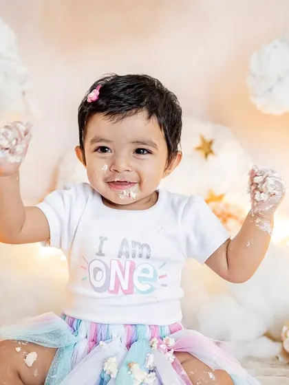 This little one is proud to be one and isn't afraid to get messy. The "I am ONE" shirt and a face full of frosting make for the perfect cake smash photo.