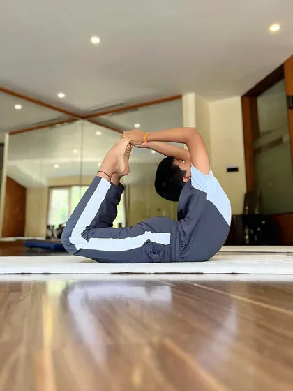We encourage our students to never rest on their laurels. This young gymnast shows great form in his bow pose, constantly working to deepen his stretch.