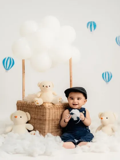 A happy smile from the little traveler in his hot air balloon basket.