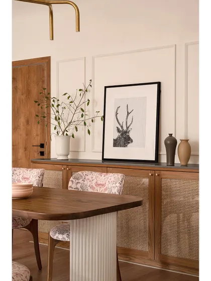 A view of the dining area in "Apartment 222," showing the harmony between the wooden furniture, paisley chairs, and the clean, paneled walls. The space feels both elegant and grounded.