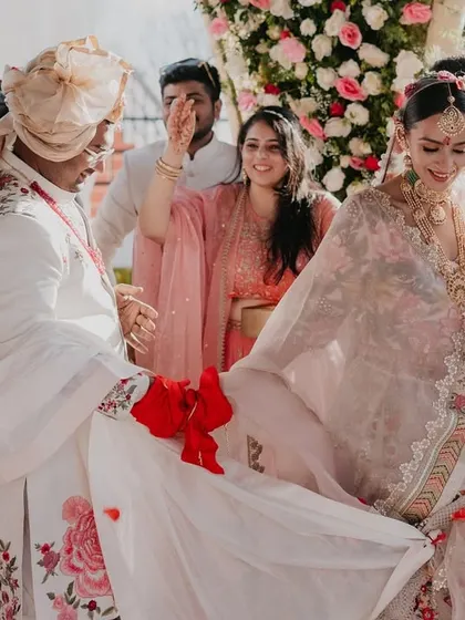 A candid moment during the ceremony in Ooty, as the groom's family playfully interacts with the couple, adding a touch of fun to the rituals.