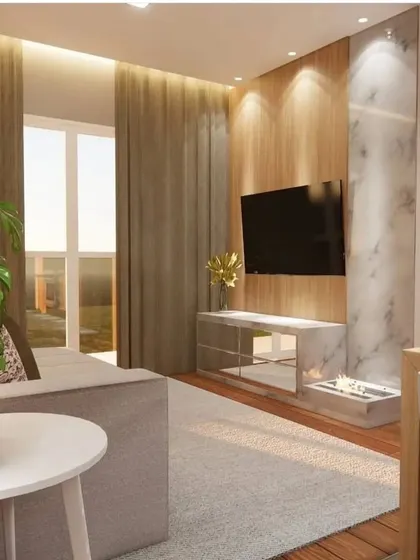 This living room features a TV unit with a mirrored finish and a marble accent wall, creating a luxurious and modern look.