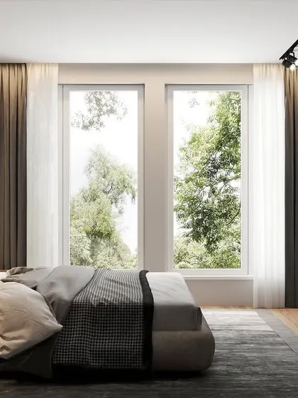A modern bedroom with a clean, natural aesthetic, featuring a geometric wood-panelled wall and large windows that overlook a green landscape.