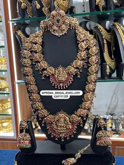 This grand temple jewellery set features a mix of red and green stones and a beautiful hair accessory.