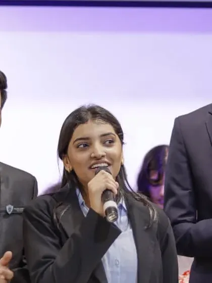 Students on stage during a formal event at their college fest, showing the variety of activities covered.
