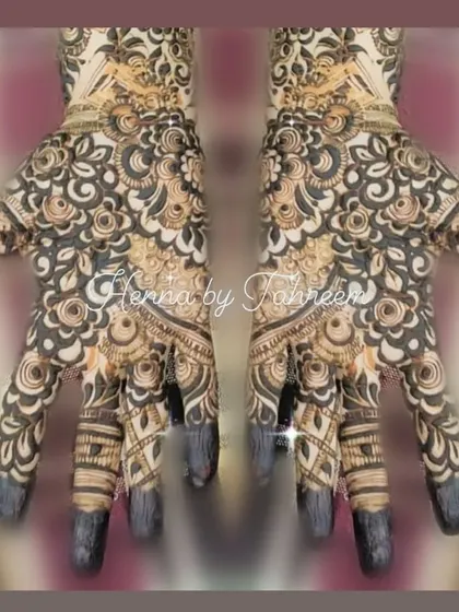 This mirrored design shows a perfectly symmetrical, heavy pattern on both hands. The tips of the fingers are fully covered in henna, a traditional style that gives a very rich stain.