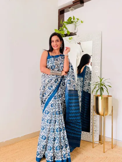 This blue and white block print style saree is a timeless classic. It's a versatile piece that is perfect for work and can be dressed up for a casual outing.
